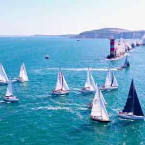 Round the Island Race 2026 yachts passing The Needles Lighthouse on the Isle of Wight captured from an aerial drone.